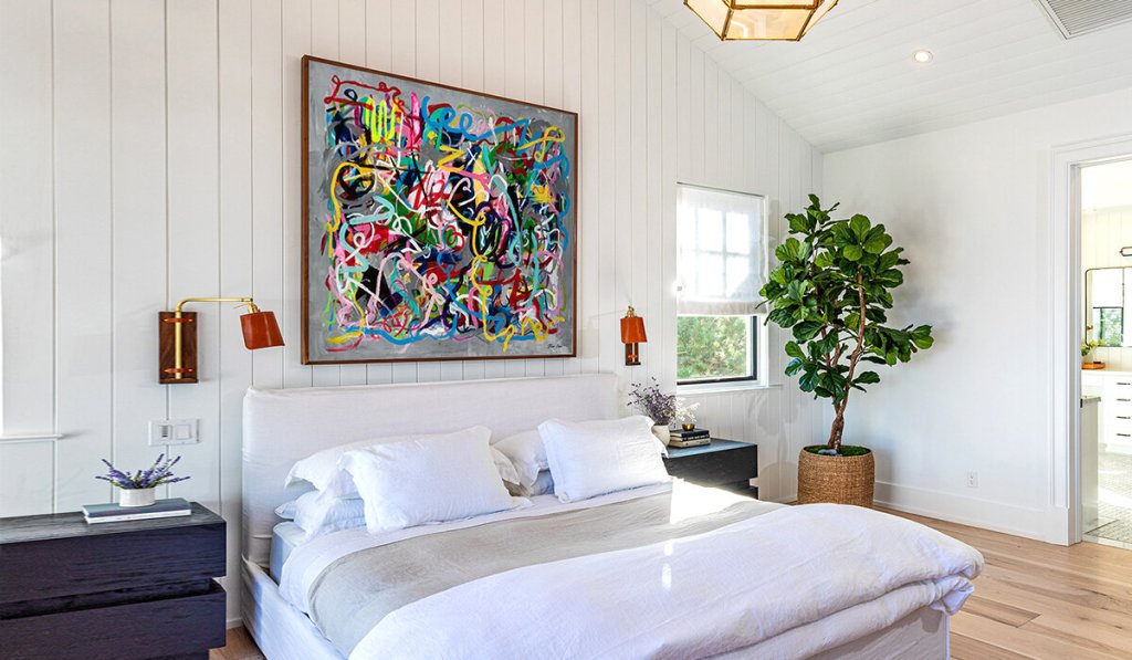 bedroom with artwork on the wall

